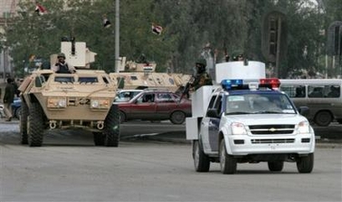 An Iraqi special police units secure the main entrance of the Ministry of Interior complex, Monday, Jan. 9, 2006, in Baghdad, Iraq.