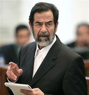 Former Iraqi President Saddam Hussein looks at prosecutors as he speaks at his trial in Baghdad December 22, 2005.