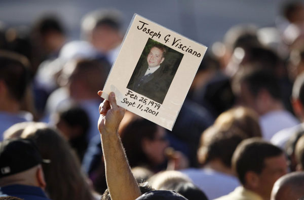 A person holds a picture remembering a victim of the attacks during ceremonies marking the 10th anniversary of the 9/11 attacks on the World Trade Center, in New York Sept 11, 2011. Mourning for 9/11 victims